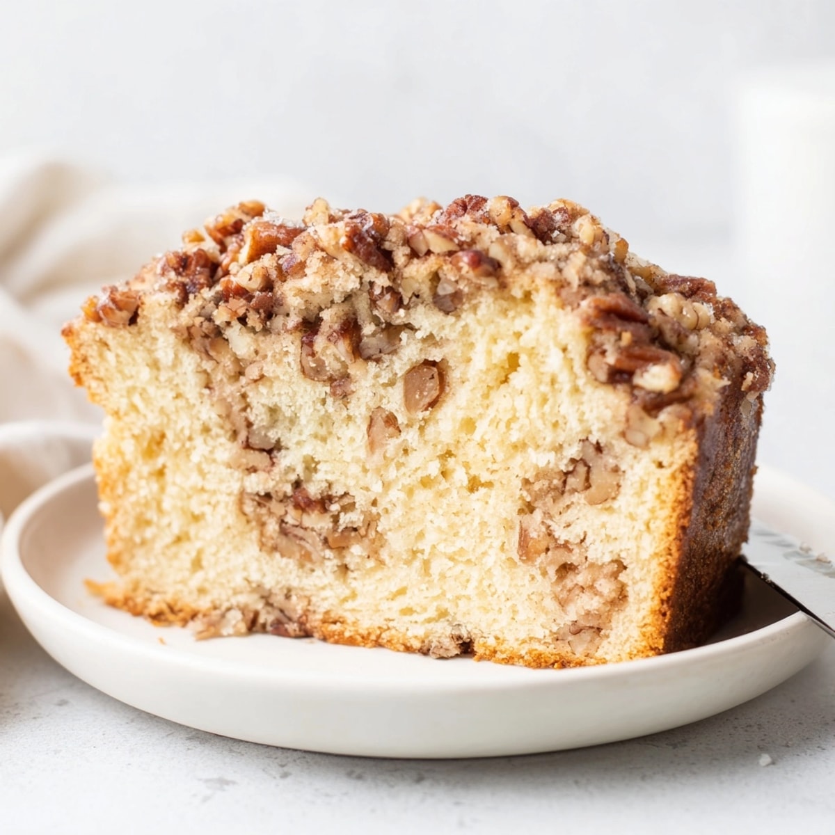 Slices of Ricotta Pecan Streusel Bread, showcasing the soft crumb and pecan streusel swirl.