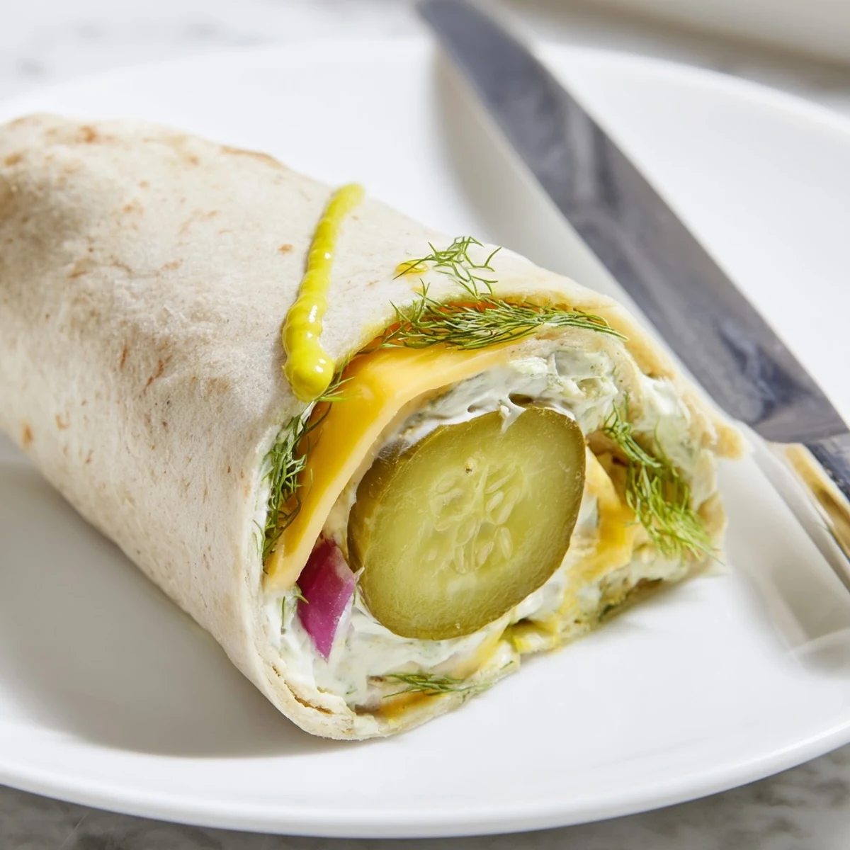 Crisp pickles and creamy cheese wrapped in tortillas for delicious Pickle-in-a-Blanket.