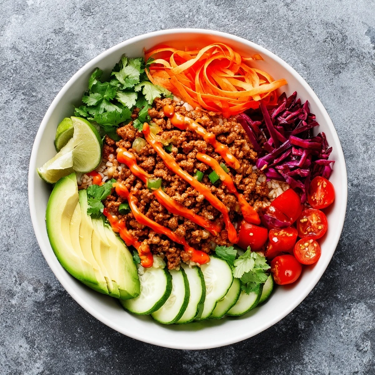 A colorful plant-based meat bowl garnished with fresh vegetables and lime wedges.  