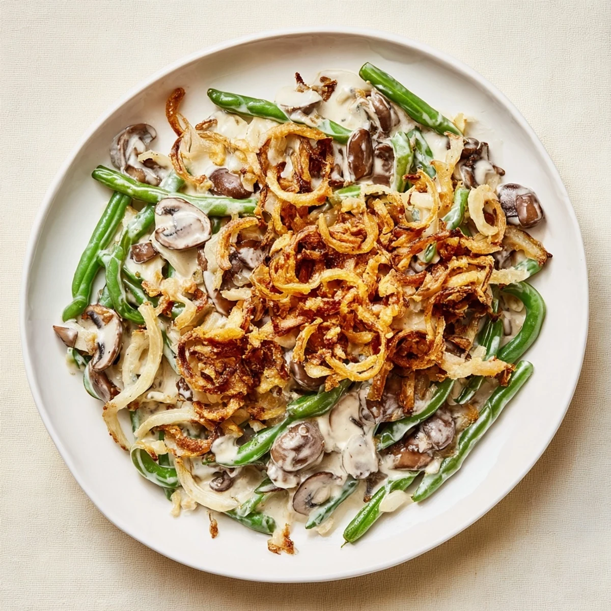 Creamy, bubbling Old-School Green Bean Casserole topped with crispy fried onions, a comfort food classic.