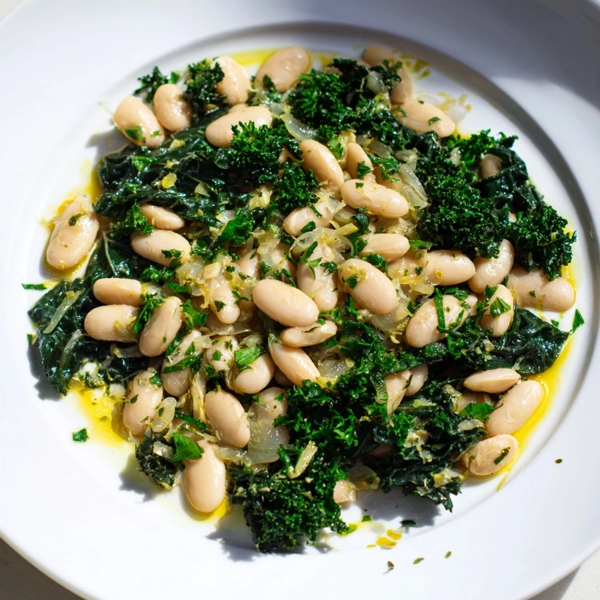 Fragrant Garlicky Beans with Winter Greens, a rustic, comforting dish, ready to serve with fresh parsley.