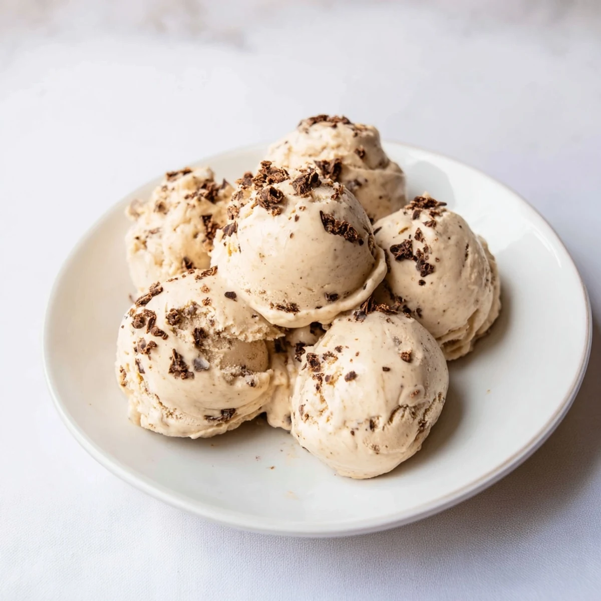 Creamy peanut butter banana ice cream swirled in a bowl, a refreshing vegan treat.