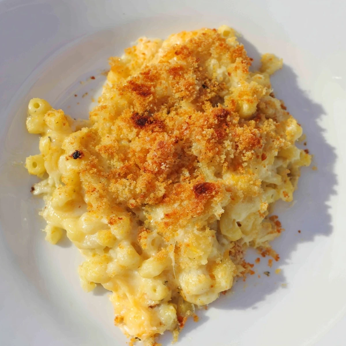 Golden-brown baked macaroni and cheese bubbling, offering a delicious, creamy cheesy texture, perfect for dinner.
