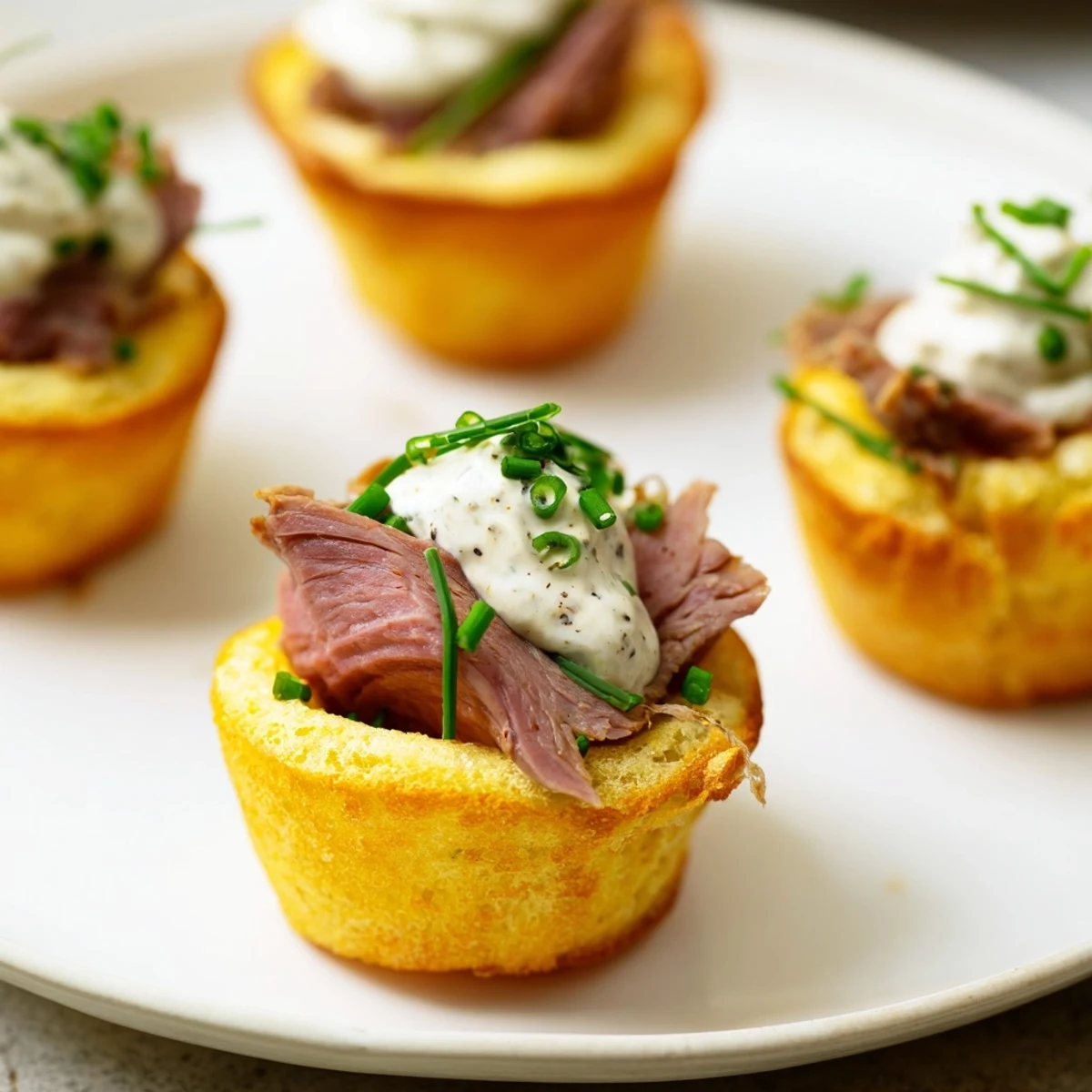 Golden, crispy Express Holiday Yorkshire Pudding Bites filled with savory roast beef and cool horseradish cream.