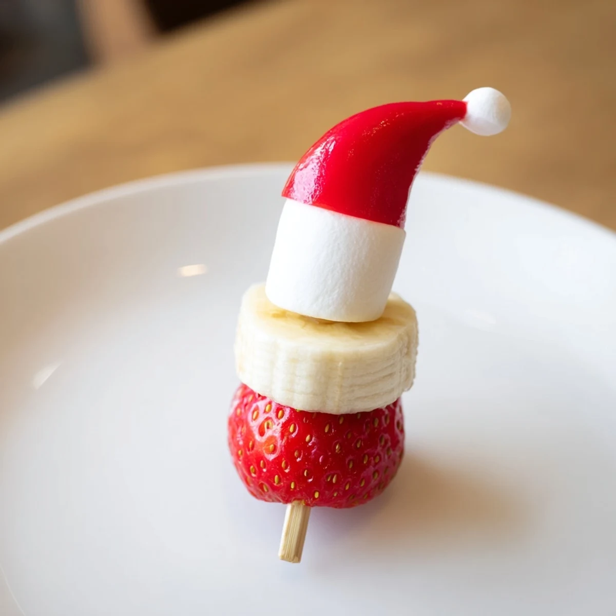 Vibrant Strawberry Banana Santa Sticks, a festive snack with fresh fruit and fluffy marshmallows arranged on skewers.