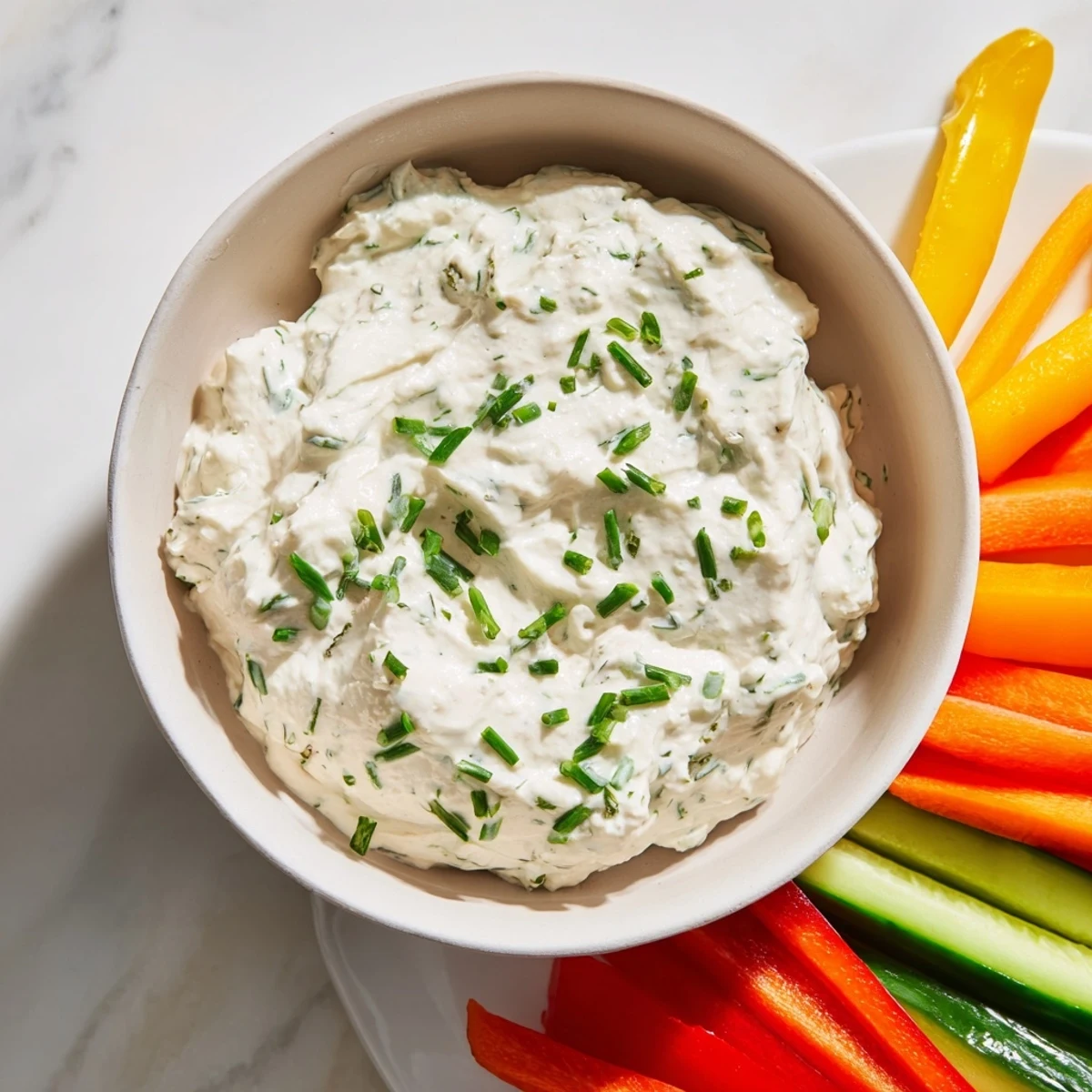 Cool, refreshing Kids Dip—a perfect party snack—served with vibrant carrot sticks, celery, and bell peppers for dipping.
