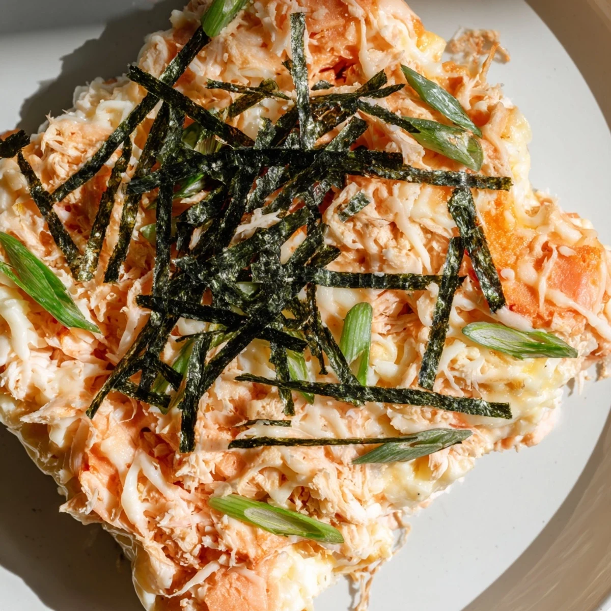 Warm, golden cheesy topping covers this easy Creamy Salmon Sushi Bake, great for sharing and enjoying.