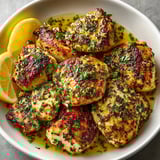 Juicy garlic herb butter chicken breasts sizzling in golden sauce, ready for serving.