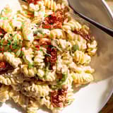 Aromatic Baked Feta Pasta 2.0, drizzled with olive oil and garnished with fresh basil.  