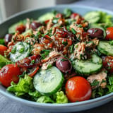 Hearty Mediterranean tuna salad featuring bell peppers, cucumber, and fresh parsley.