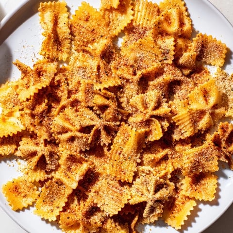 Crispy pasta chips seasoned variety, perfect for dipping and snacking with friends.  