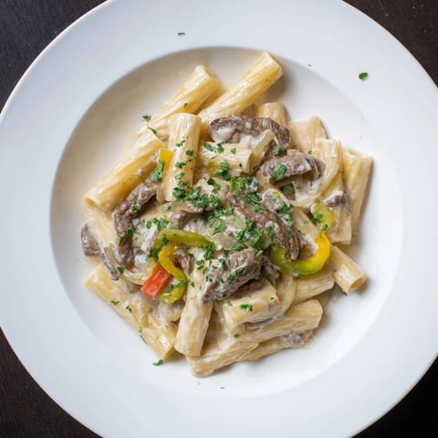 Delectable Philly cheese steak pasta loaded with tender beef and creamy melted cheese, ready to eat!