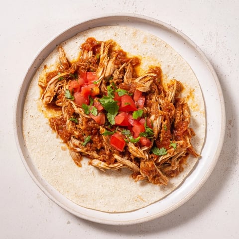Steaming Crock-Pot shredded chicken tacos, ready to be wrapped in soft tortillas with fresh toppings.