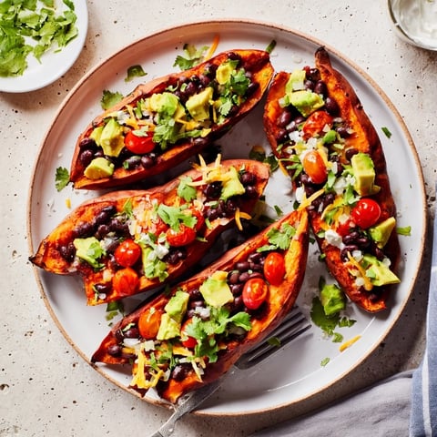 Golden, fluffy Loaded Baked Sweet Potatoes, brimming with flavorful black beans and fresh toppings.