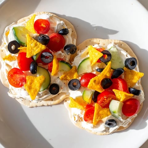 Gold Medal Olympic Ring Appetizers arranged on a platter, featuring colorful toppings atop creamy crackers.