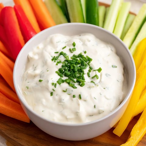 Creamy Kids Dip with ranch, surrounded by colorful, crunchy veggie sticks, is ready to be enjoyed.