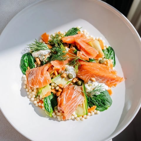 Artfully arranged Infinity Loop Flow: Flaky salmon, fresh veggies, and couscous in figure-eight.