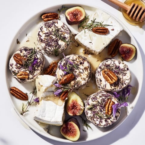Elegant cheese board of The Lavender Haze recipe, featuring goat cheese, brie, and lavender honey.