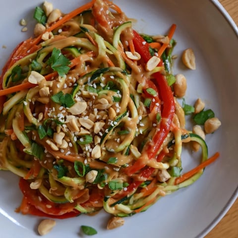 Bright zesty peanut zucchini noodles salad, with colorful vegetables and a creamy peanut dressing.