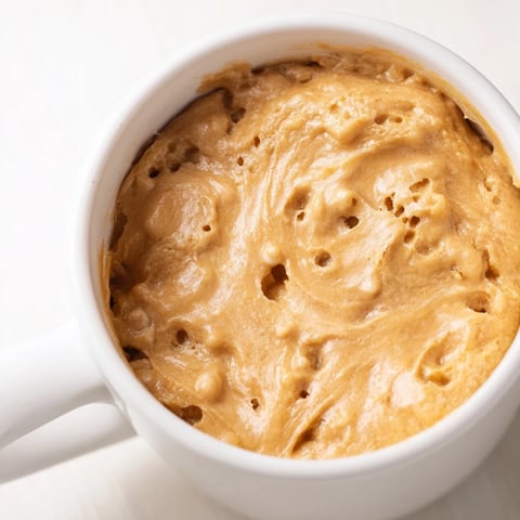 Warm, fluffy, 2-Minute Peanut Butter Mug Cake, ready to eat right from your favorite mug.