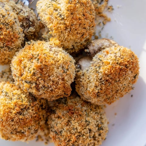 Crispy, golden ranch-seasoned mushrooms ready to serve, a flavorful appetizer for snacking.