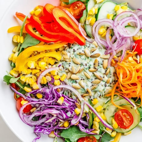Bright rainbow salad of colorful vegetables tossed with creamy tahini dressing, delicious.