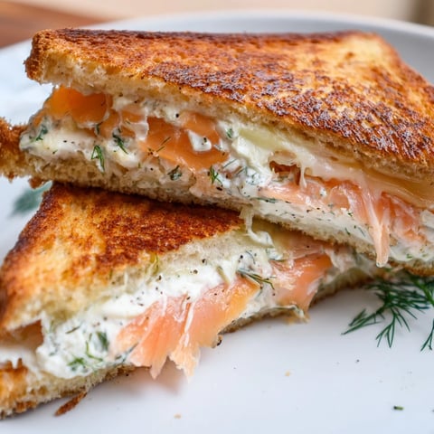 Golden, melty Smoked Salmon Grilled Cheese sandwich, served warm, oozing with cheese and salmon.