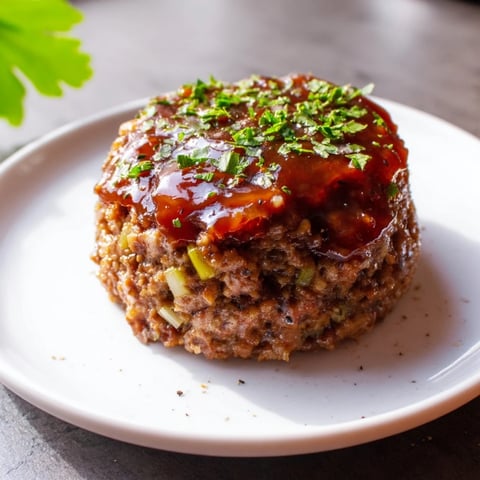 Mini Meatloaf Bites, glazed and golden brown, are ready to serve with their savory aroma.