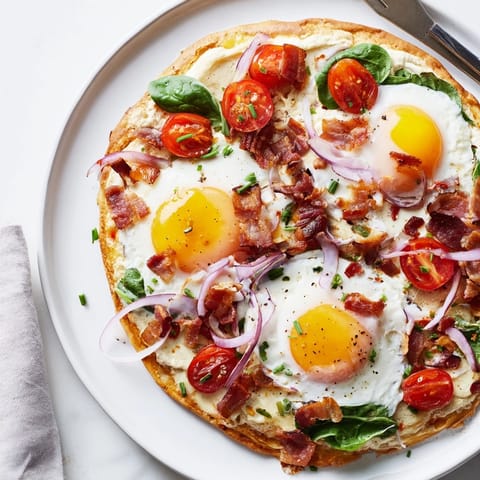 A slice of Breakfast Pizza showing a runny yolk, melted cheese, and crispy crust invitingly.
