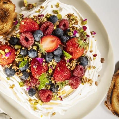 Whipped cream cheese and vibrant berries create a delightful Butter Board Dessert.  