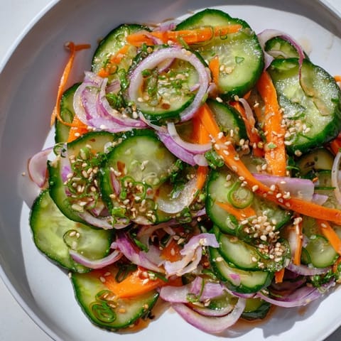Refreshing cucumber salad remix drizzled with tangy dressing, perfect as a light side.  