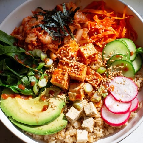 Colorful fermented vegetable bowl showcasing kimchi, fresh vegetables, and hearty grains.  