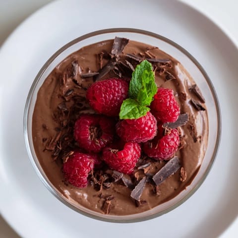 Dark chocolate shaved over creamy avocado chocolate mousse provides a delightful texture with fresh berries.