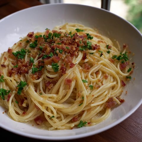 The aroma of garlic butter sauce embraces tender pasta topped with Garlic Butter Pasta's bacon.