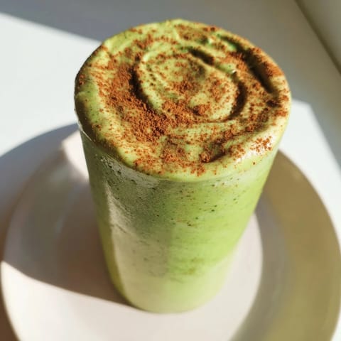 Vibrant Matcha Snickerdoodle Protein Shake, a creamy blend showcasing green matcha and cinnamon's cozy flavors.