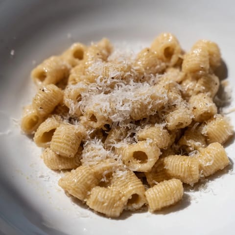 A close-up of finished 15-Minute Garlic Parmesan Pasta, sprinkled with fresh parsley and extra Parmesan.