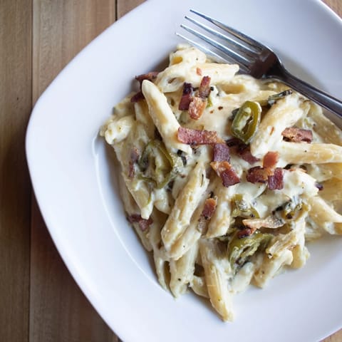 Freshly chopped chives and a forkful of gooey cheese sauce showcase the rich texture and smoky paprika notes in this decadent Jalapeño Popper Pasta.