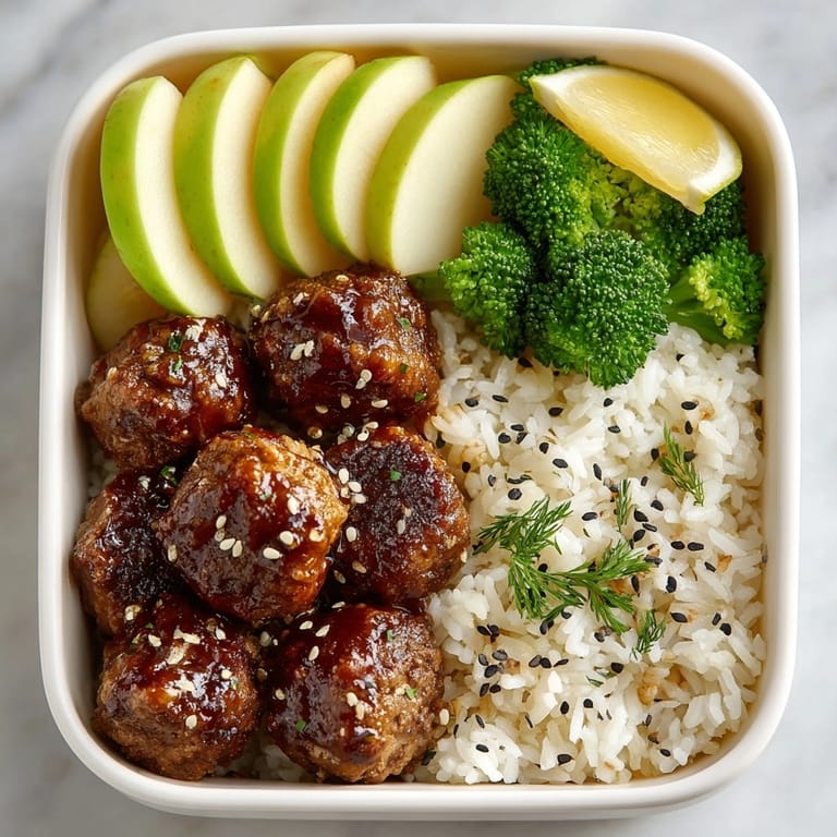 Delicious cream soda BBQ meatball bento, showcasing saucy delights in a perfectly packed, flavorful meal.