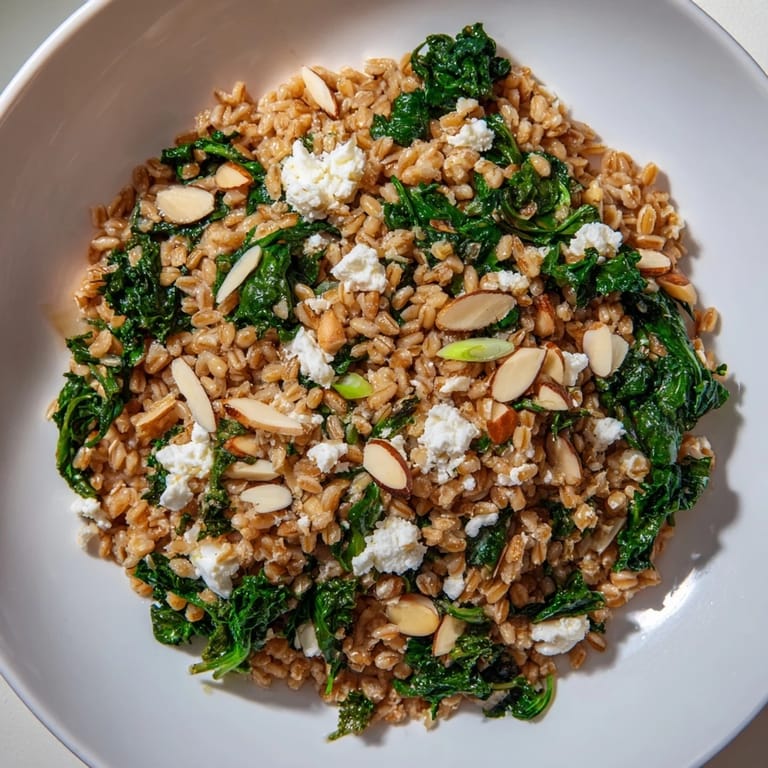 Close-up of a warm farro and greens pilaf, featuring vibrant vegetables and delicious ingredients.