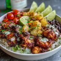 Colorful Chicken Pineapple Taco Bowls with Coconut Rice, featuring juicy spiced chicken, sweet pineapple salsa, and creamy rice, topped with avocado and fresh cilantro.  